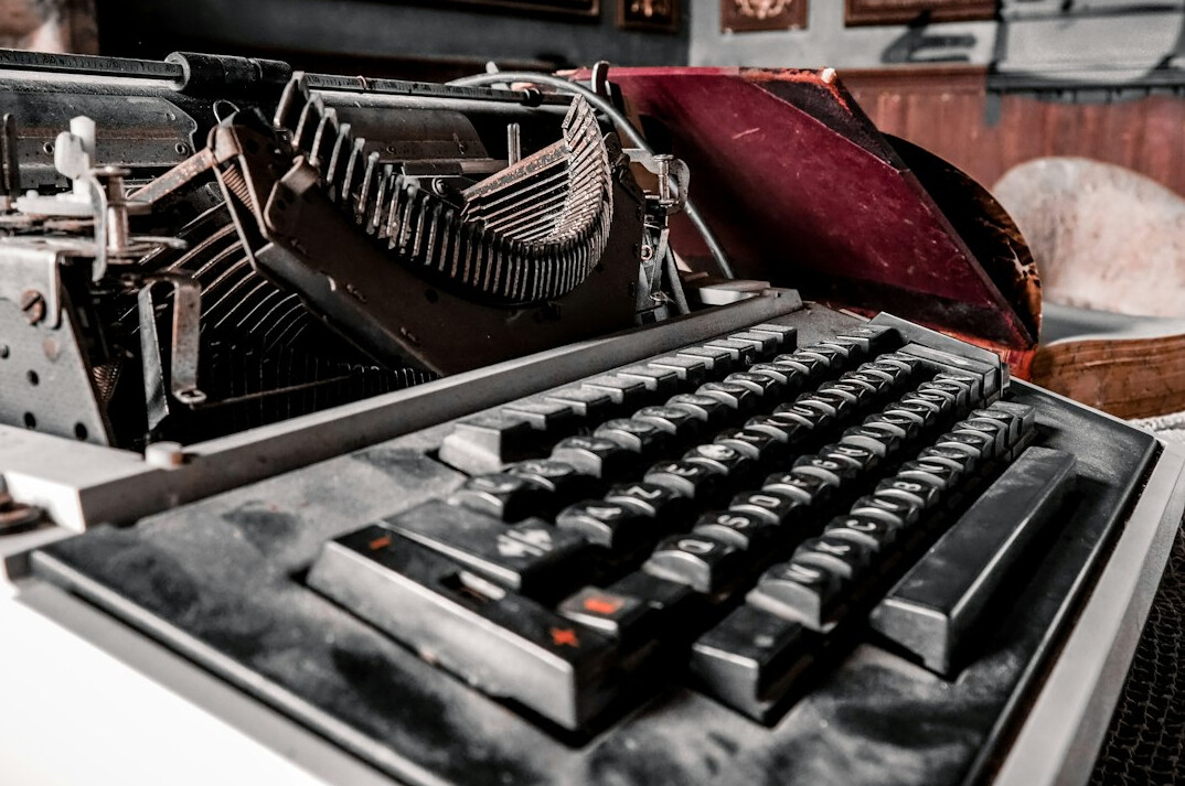 Vintage typewriter with old documents and papers on a desk