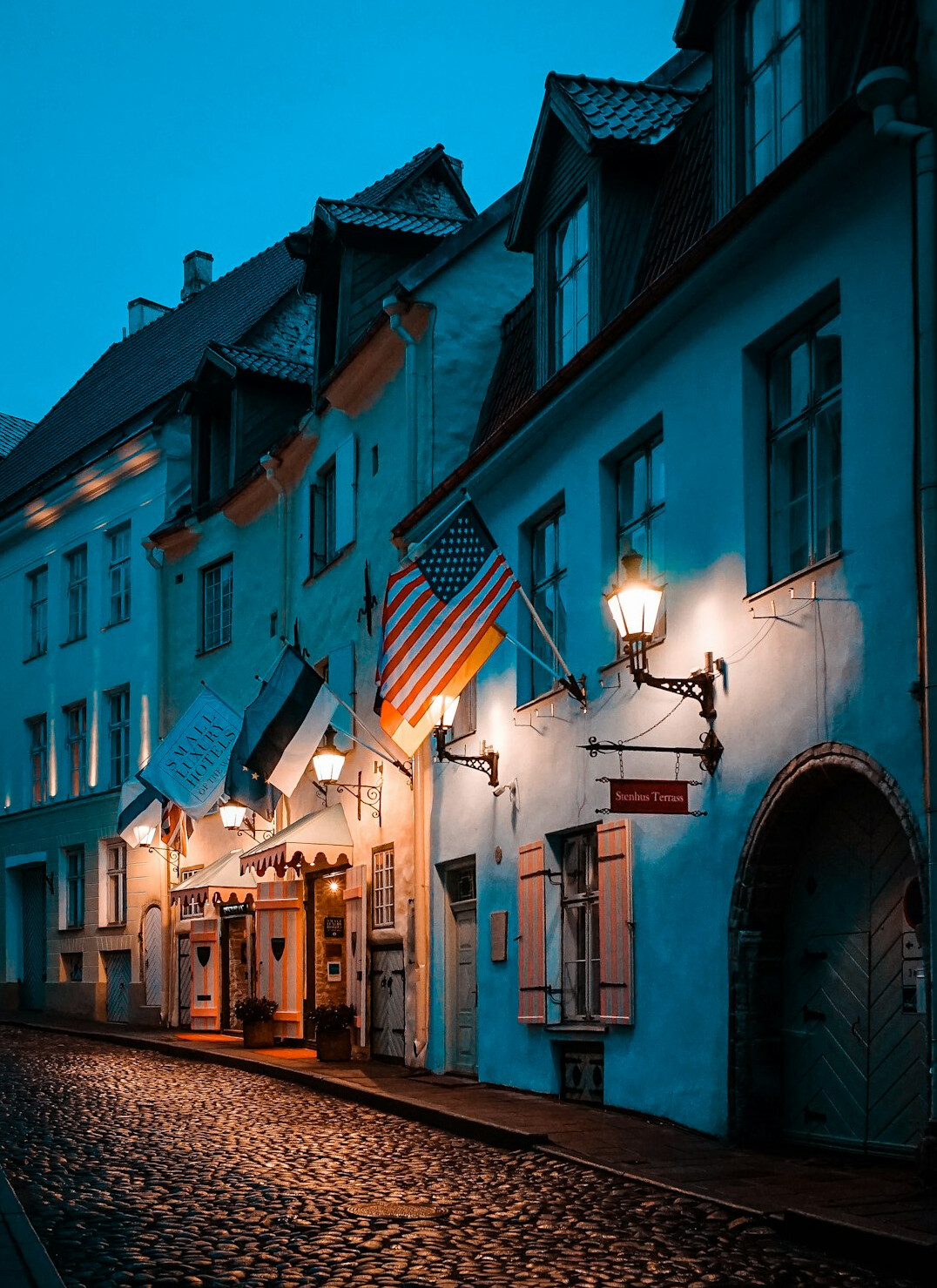 Historic cobblestone street with old colonial buildings at dusk